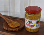 Jar of Brian's Maridzano hot pepper jelly on a wooden tray with a wooden spoon.