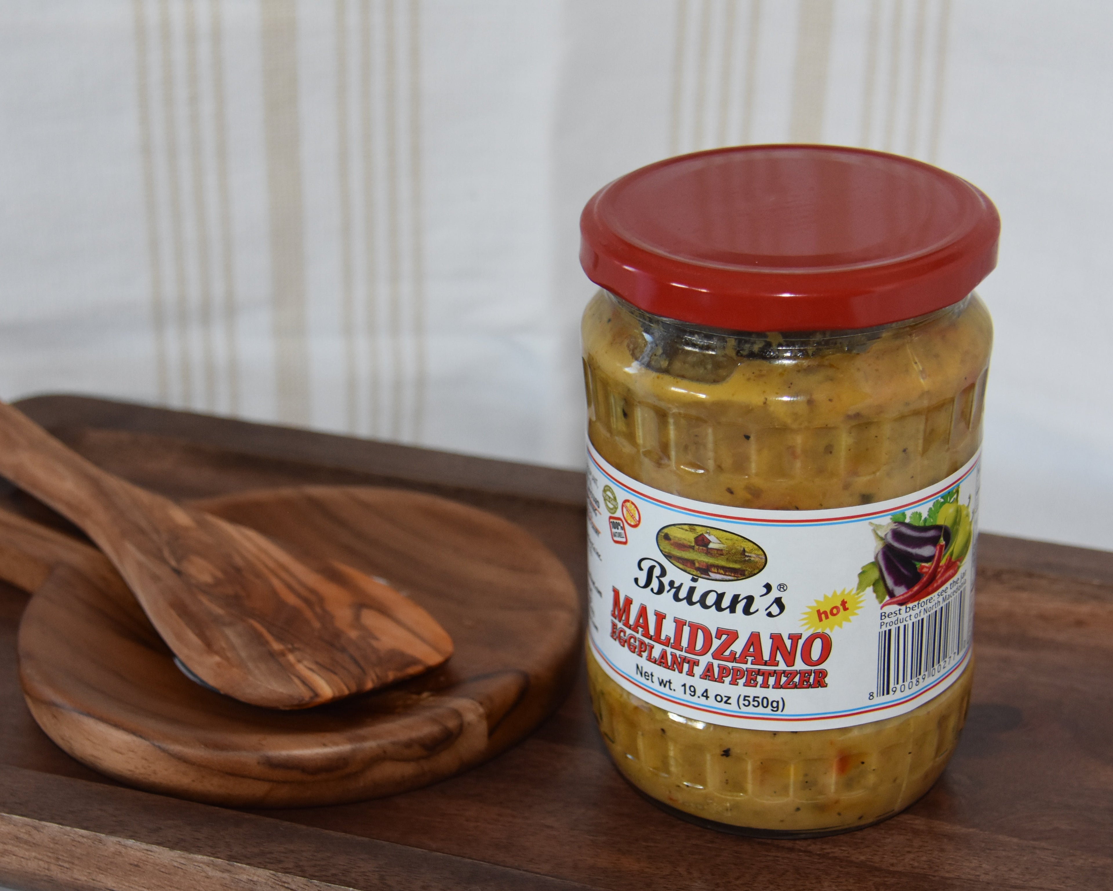 Jar of Brian's Malizano on a wooden tray with wooden spoons