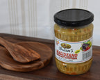 Jar of Brian's Malizzano pasta sauce on a wooden tray with wooden spoons.